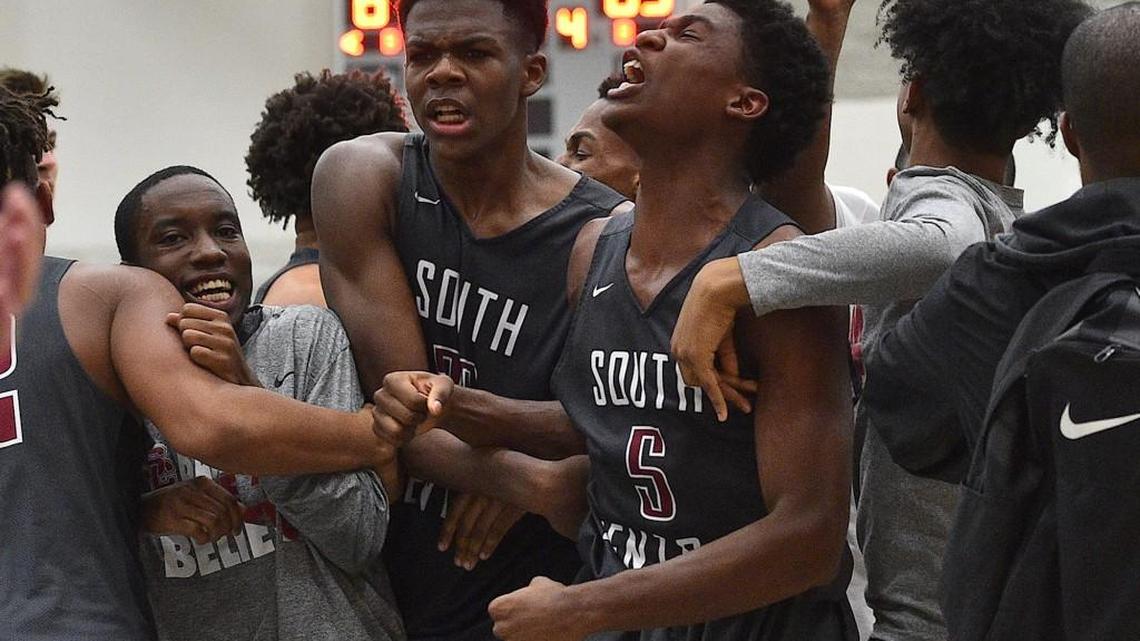 South Central's Cydney Williams (5) and Day'ron Sharpe (23) celebrate with teammates and fans after their victory over Garner in the NCHSAA 4A playoffs. The South Central Falcons took on the Garner Trojans in the fourth round of the NCHSAA4A boys basketball play offs in Garner, N.C. on February 27, 2018. South Central edges Garner 69-67.