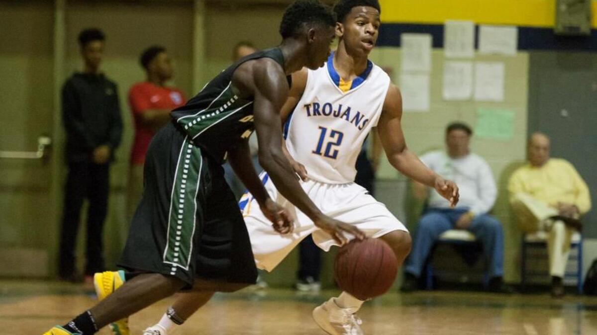 Garner's Thomas Allen (12) guards Southeast Raleigh's Devion Gulley (3) during the High School Basketball game between Southeast Raleigh and Garner on Tuesday, December 8, 2015 in Garner, N.C. Garner won 73-51.