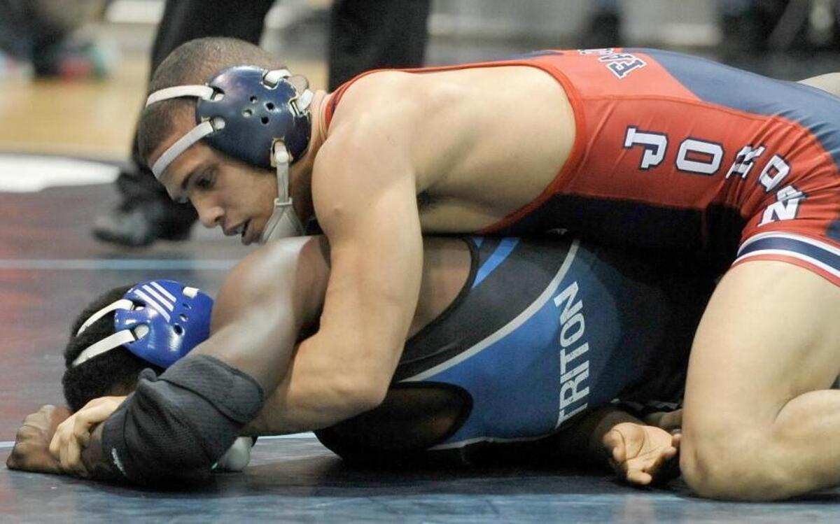 Jordan's Maliik Marcin (top) takes 1st place against Triton's Jeffery Hannah with a winning score at the 152 lbs match, during The Cpl. Pruitt Rainey Wresting Invitational at Cleveland High School, Saturday, January 9, 2016, Clayton, N.C.Damon Thomas