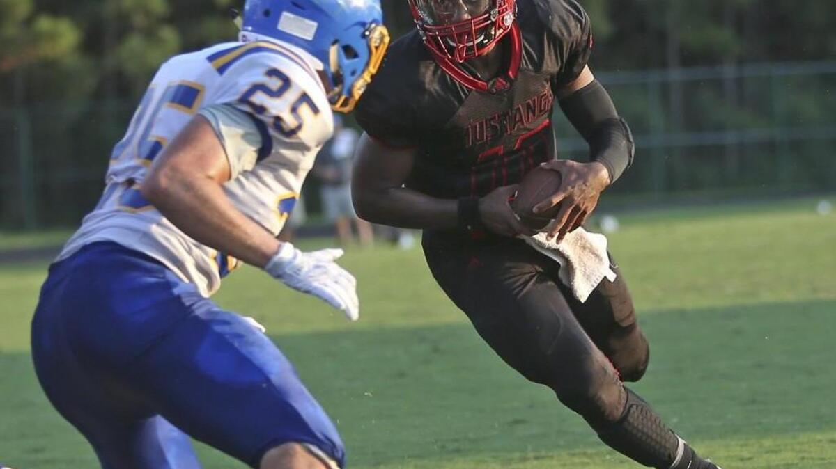 Middle Creek quarterback Dominique Shoffner (12) eyes the end zone as he runs in of first Mustang score to even the game at 7-7.