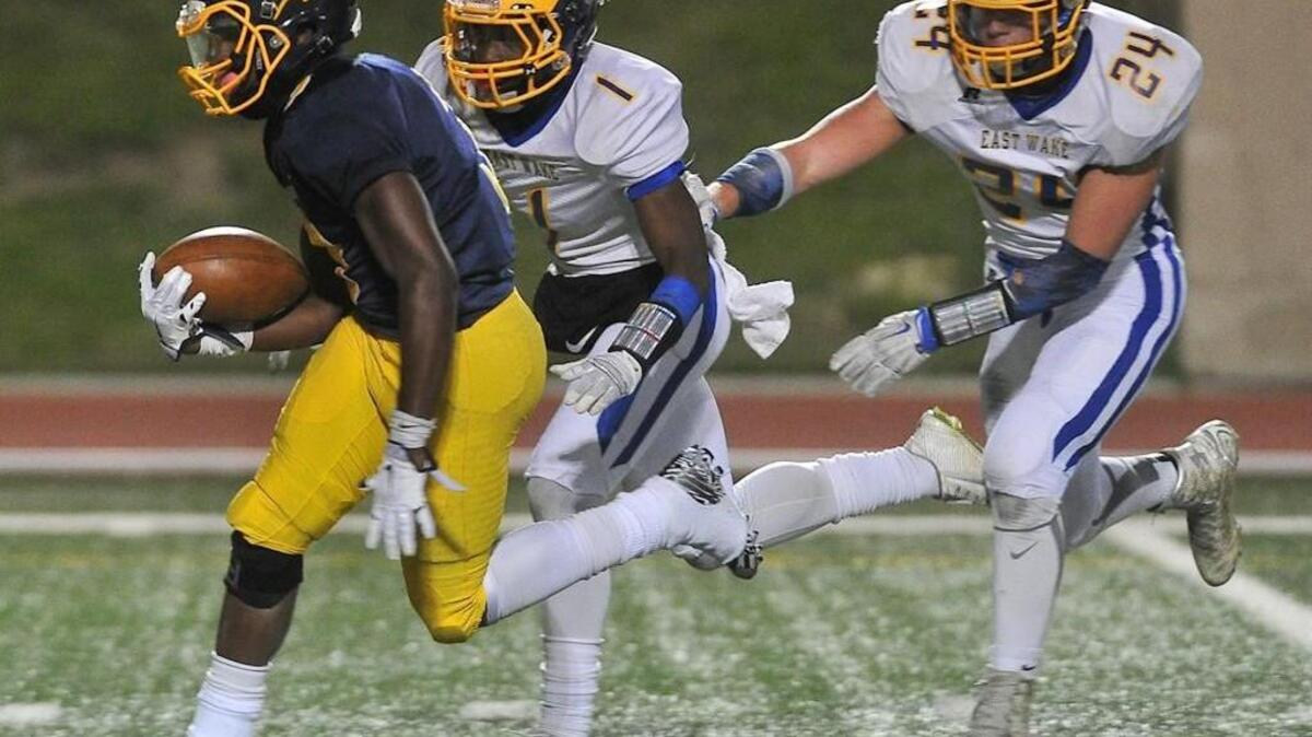 Northern Durham’s Domineke McNeill (3) runs for the touchdown followed by East Wake's Chris Ajagbawa (1) and Jake Ellington (24). The East Wake Warriors took on the Northern (Durham) Knights in a first round NCHSAA 4A playoff game in Durham, N.C. on Friday November 13, 2015. Northern Durham wins 40-35.