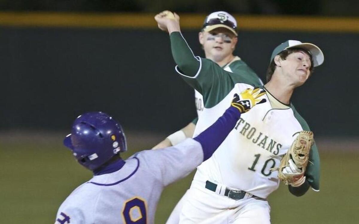 South Johnston shortstop Sauyer Roberts (10) puts out Corinth Holder baserunner Kahlil Hodge (9) and makes the relay throw to complete the double play that ended Corinth Holders 3 run rally in the 5th inning. Coverage from the prep baseball game between the Corinth Holders Pirates and the South Johnston Trojans played in Four Oaks, N.C. on Friday April 8, 2016. South Johnston defeated Corinth Holders 7-6.