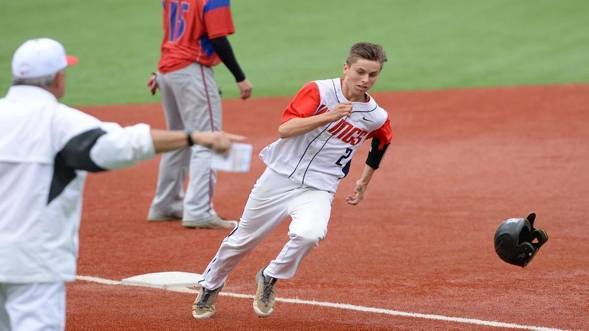 Chase Sykes (2) of Voyager Academy steps on to the third base under the directions from his coach Pete Shankle, left, to score for the Vikings. The Voyager Academy Vikings played the Gates County Red Barons in a baseball game that took place at the Duke University Coombs Field in Durham, N.C. on Friday, May 20, 2016. Voyager won 11-0.