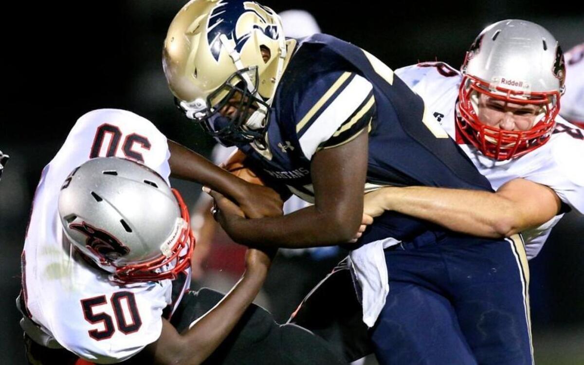 
Smithfield-Selma's Tyquan Dublin (35) drags North Johnston's Kamarei Taylor (50) and Dallas Krob (8) during the North Johnston High School football game against Smithfield-Selma High School, September 18, 2015 in Smithfield, N.C. North Johnston won 27-0.
