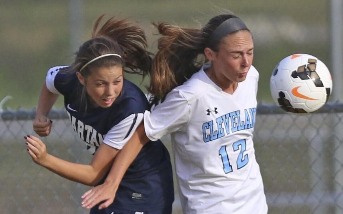 Smithfield-Selma’s Mollie Lane (2) collides with Cleveland’s Kendall Lamm (12) trying to control a pass into the box.