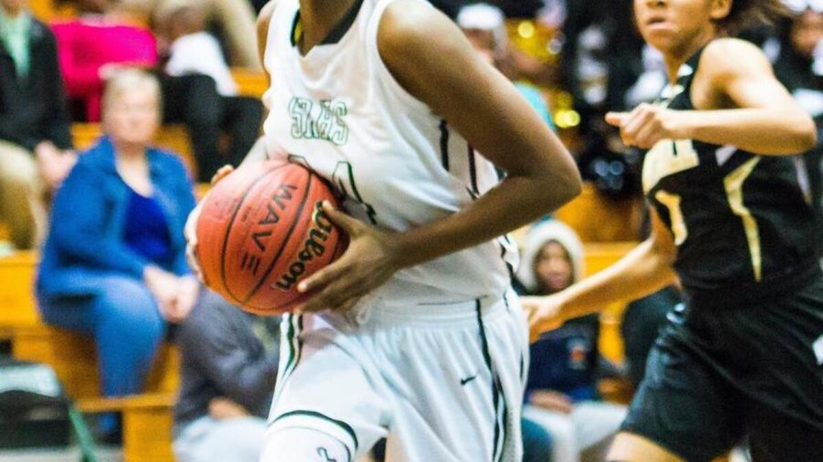 Southeast Raleigh’s Kia Adams (24) drives to the basket during a girls’ basketball game earlier this season.