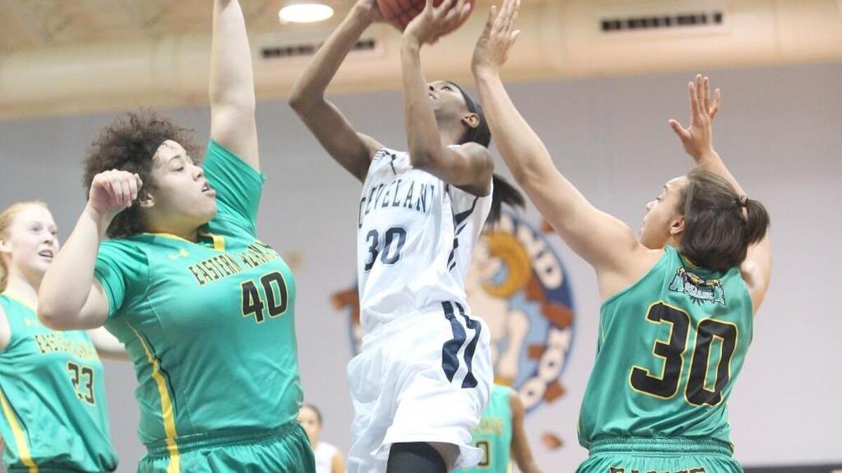 Cleveland’s Myrayna Watkins (30) drives between Eastern Alamance’s Bree Evans (40) and Midori Long (30).