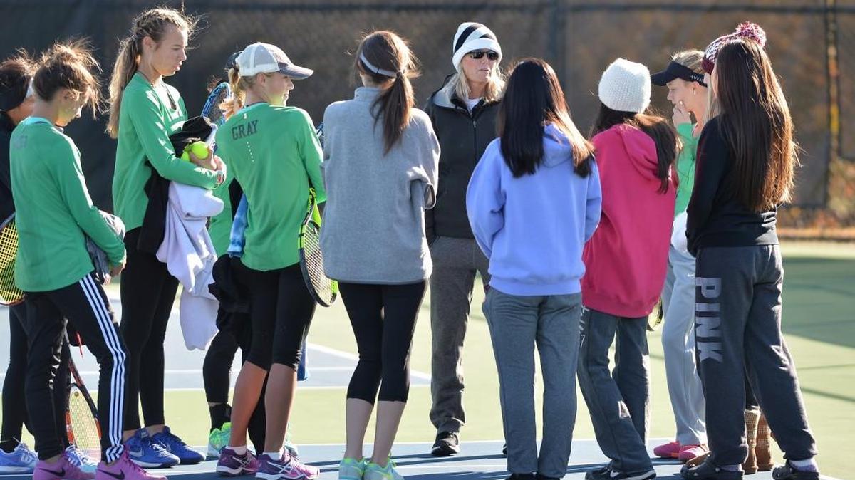 Pam Gilbert, center, head coach of Green Hope talks to her players before the start of the women dual team tennis games between the Green Hope Falcons and the Myers Park Mustangs that took place at the Burlington Tennis Center in Burlington, N.C. on Saturday, November 12, 2016.