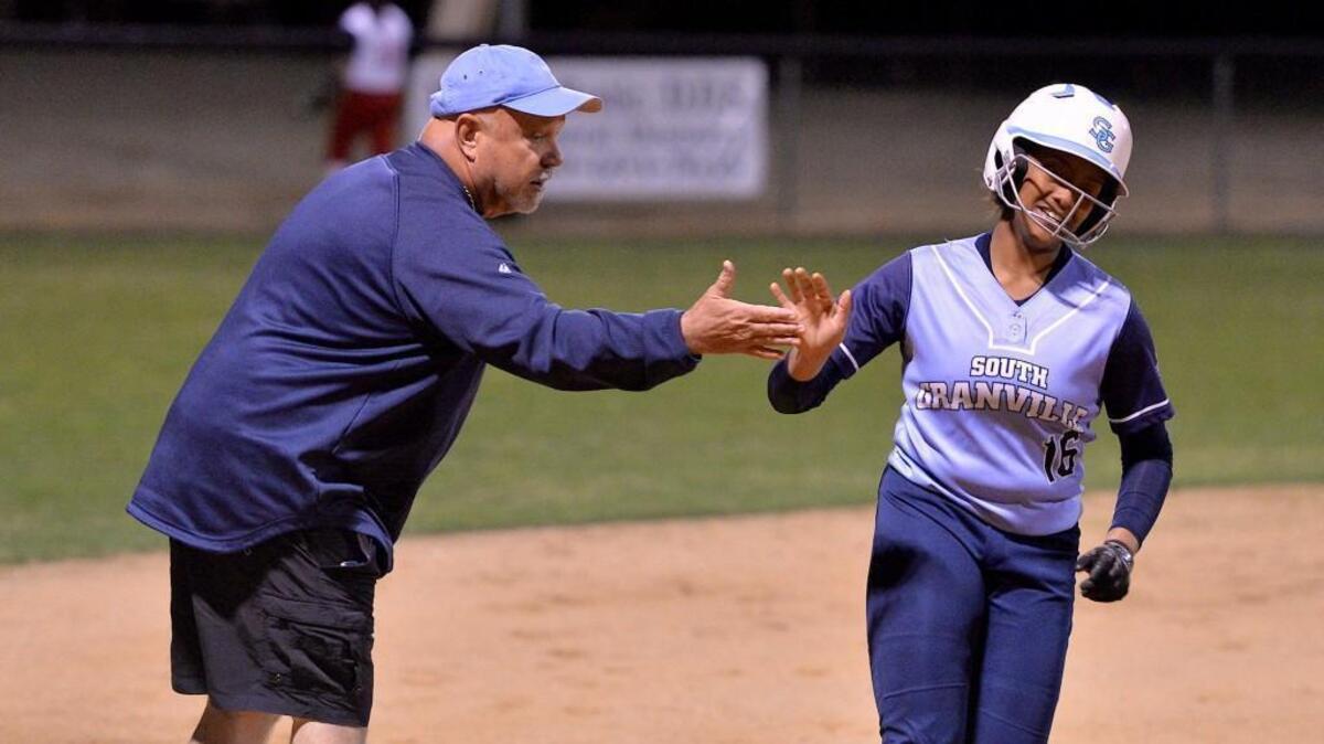 South Ganville head softball coach Walter Day congratulates Brianne Coleman (16) after hitting a solo home run in th sixth inning. The South Granville Vikings took on the J.F. Webb Warriors in a non-conference softball game in Oxford, N.C. on March 8, 2017. South Granville wins 9-4.