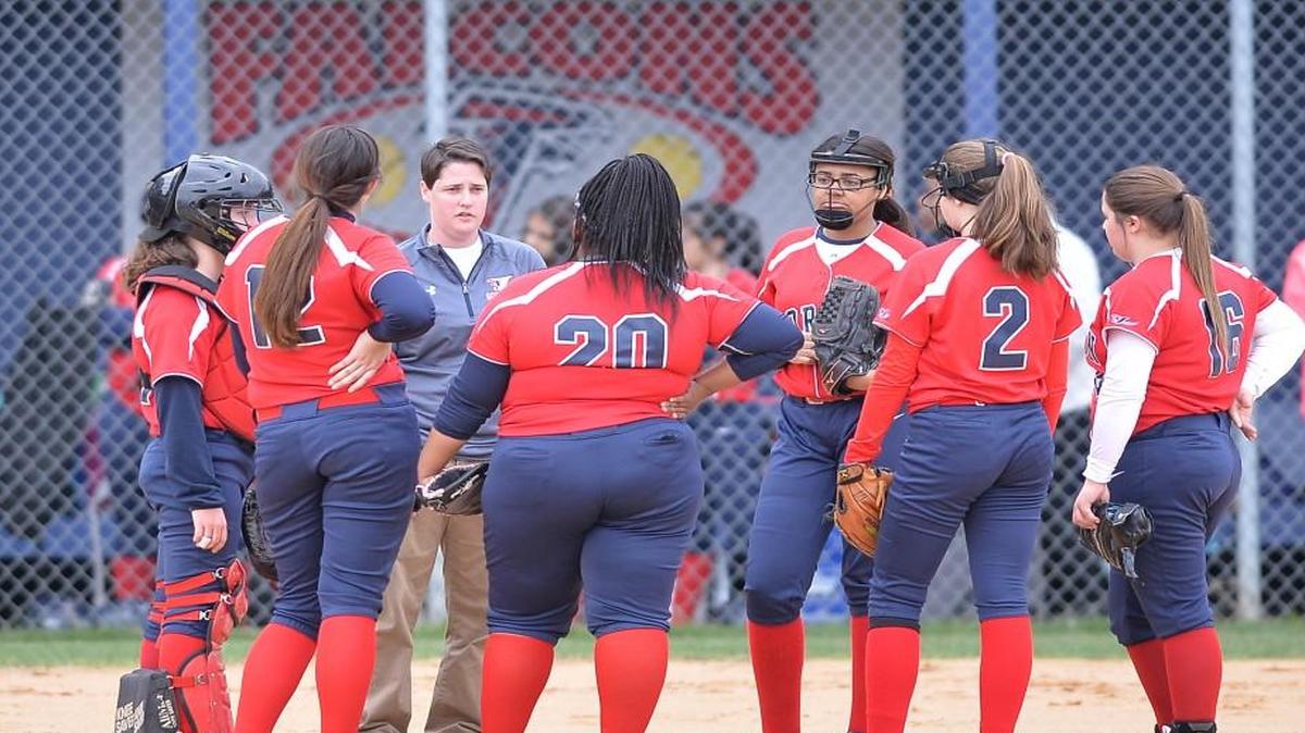 Kristen Gillespie, third from left, Jordan's head coach instructs her players at the mound. The Northern Durham Knights played the Jordan Falcons in a softball game that took place in Durham, N.C. on Friday, March 17 2017. Northern Durham won 21-0.