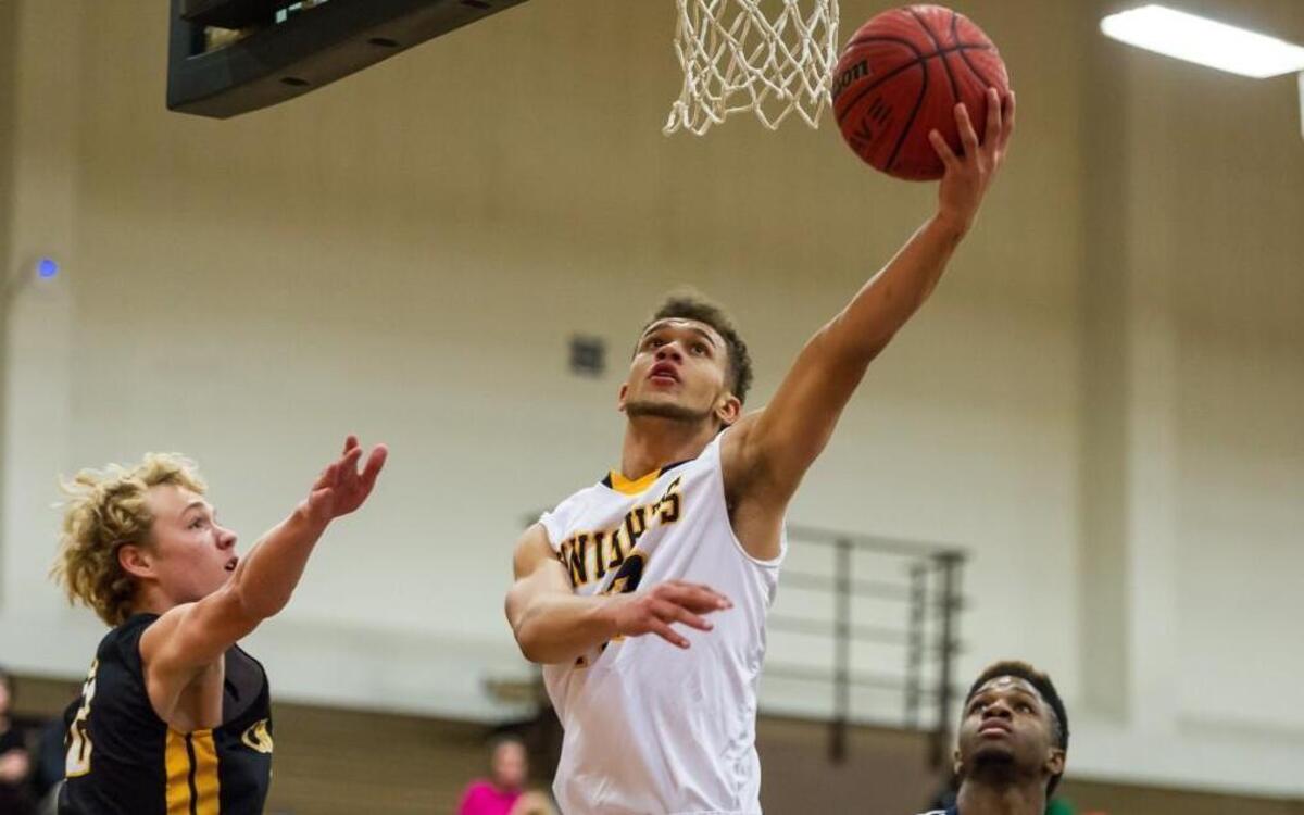 Northern's Emmett Tilley (12) lays in a basket for two of his game-high 21 points Tuesday night against Chapel Hill. Northern won 76-50 in Poe Gym on Tuesday, November 17.