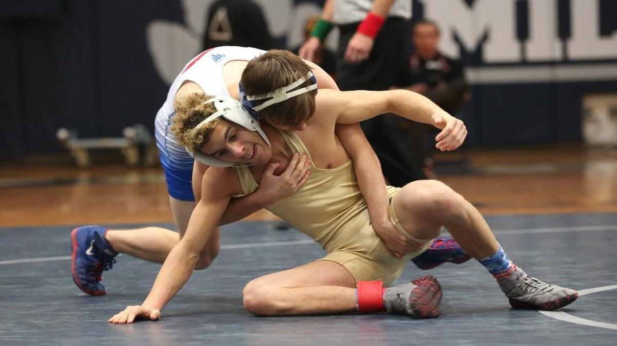 Wake Forest's Joey Hannum (behind) takes control of Leesville Road'd Justin Tibbs1 during the Cap-8 wrestling conference match at Millbrook High school on January 28 , 2017, in Raleigh , N.C .