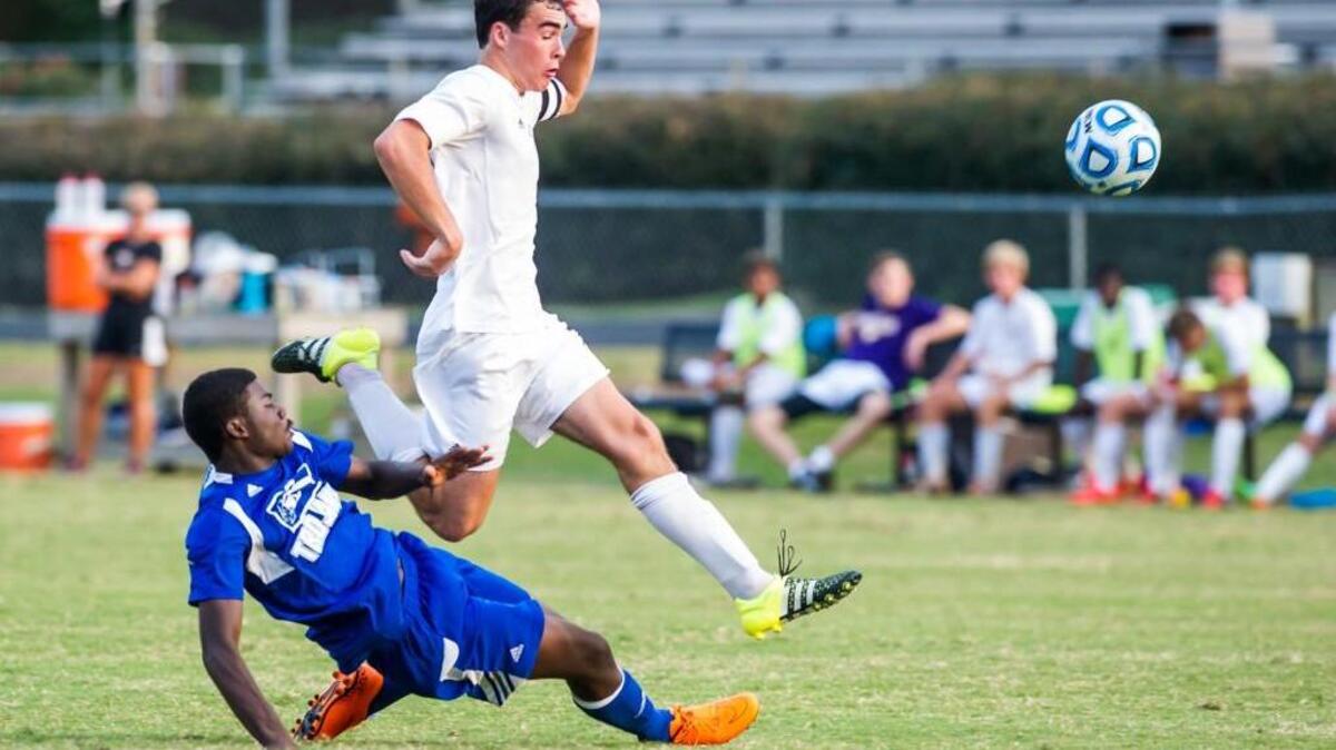 
Broughton senior Bryant O'neal (20) and Garner sophomore Shamari Henderson (18) fight for control of the ball during a soccer game played on Monday, August 17, 2015. Broughton won 7-1.
