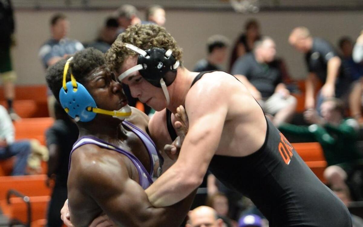 Payton Wilson, right, of Orange wrestles Larry Williams, left, of Corinth Holders during the 220 lbs final. The Jim King Orange Invitational Wrestling Tournament was hosted by Orange High School in Hillsborough, N.C. on Saturday, December 3, 2016.