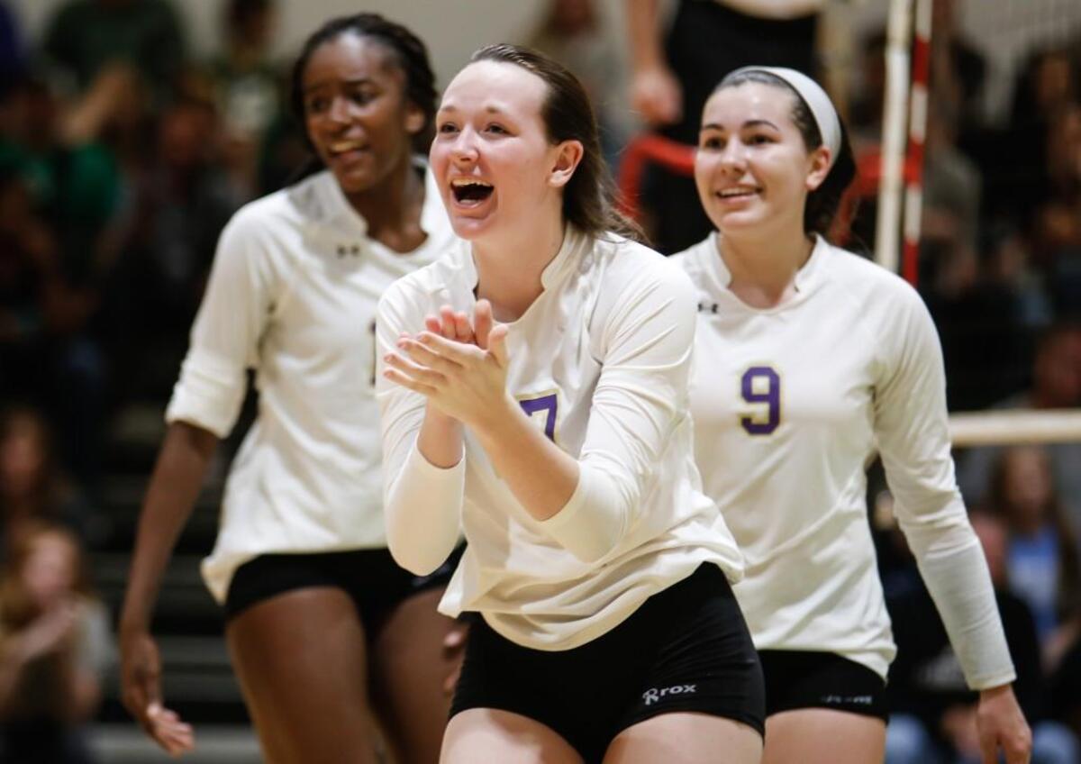 Broughton's Nan Parrish (17) celebrates a late point with her teammates Jade Demps (15) and Holli Smith (9) during Broughton's volleyball game at Cardinal Gibbons on Saturday, October 29, 2016. Broughton won the game 3-2.