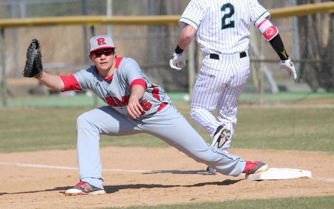 Rolesville's Spencer Hicks (16) waits for the call as West Johnston's Noah Liles (2) passes first base during the Rolesville Rams high school baseball game with the West Johnston Wildcats high school , March 17, 2017, in Benson , N.C. Rolesville won the game 6-5.