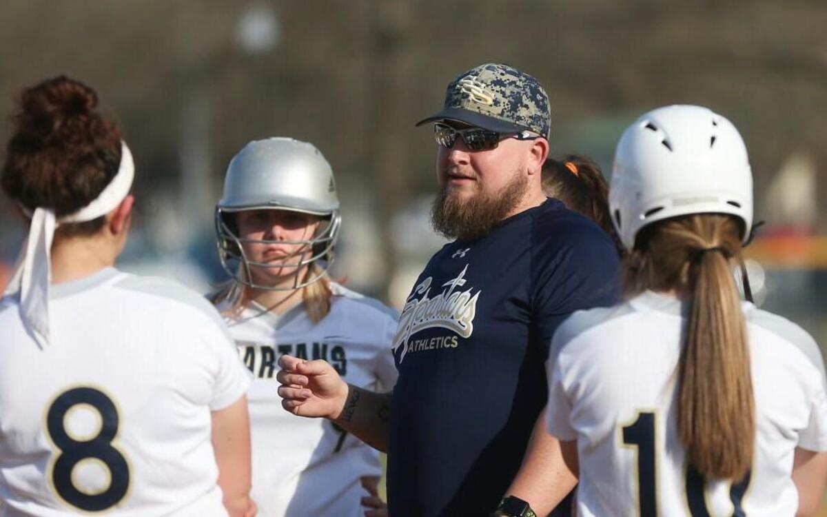 Smithfield-Selma coach T.J. Tamer talks with his players during a break in the action. Coverage from the prep softball game between the Smithfield-Selma Spartans and the Western Harnett Eagles played in Smithfield, N.C. on Friday, March 24, 2017. Western Harnett defeated Smithfield-Selma 17-1 in 5 innings.