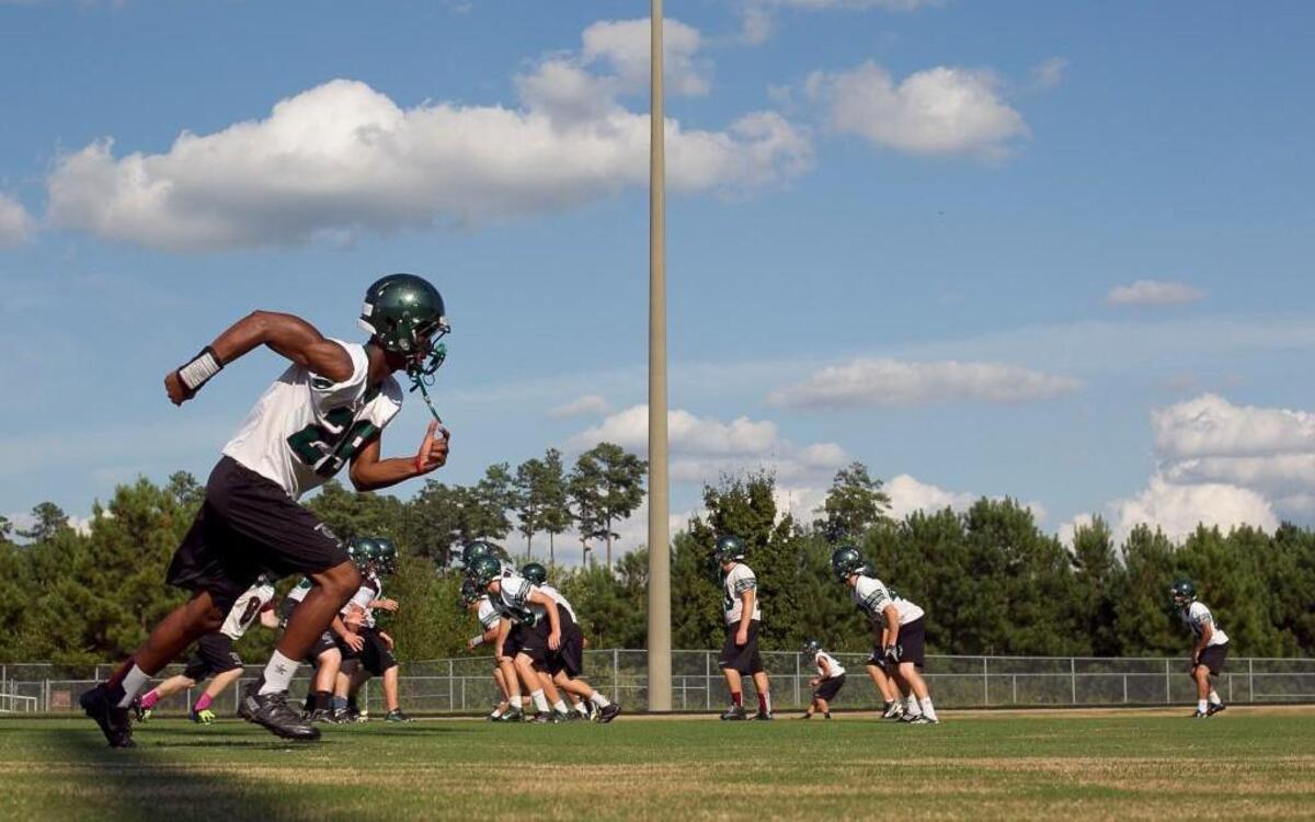 Green Hope wide receiver Bryce Dixon (29) works out with his teammates during their final practice before their season opener on Thursday afternoon Augsut 22, 2013 at Green Hope High School in Cary, N.C. The Falcons will play Cardinal Gibbons on Friday night