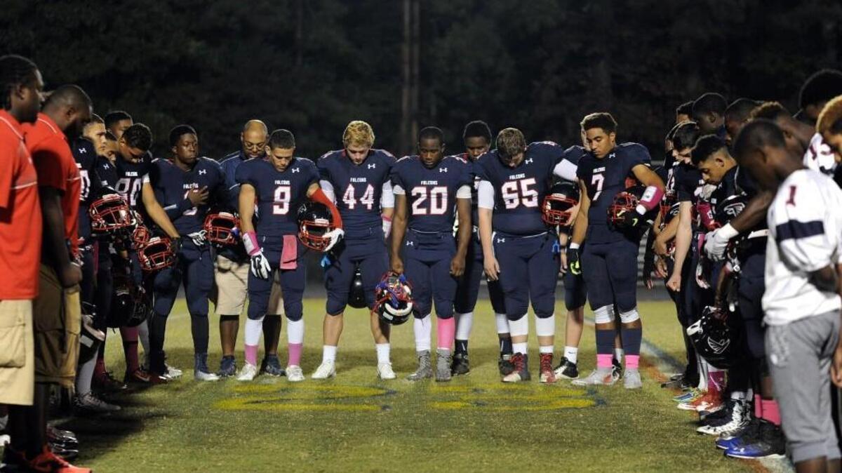 The Jordan High School football team observed a moment of silence while gathered around Brandon Massey's number before the football game against Riverside, which was played on Friday, October 23, 2015 in Durham. Massey suffered a broken neck last week making a tackle at the Cardinal Gibbons game, which was called early due to injury.