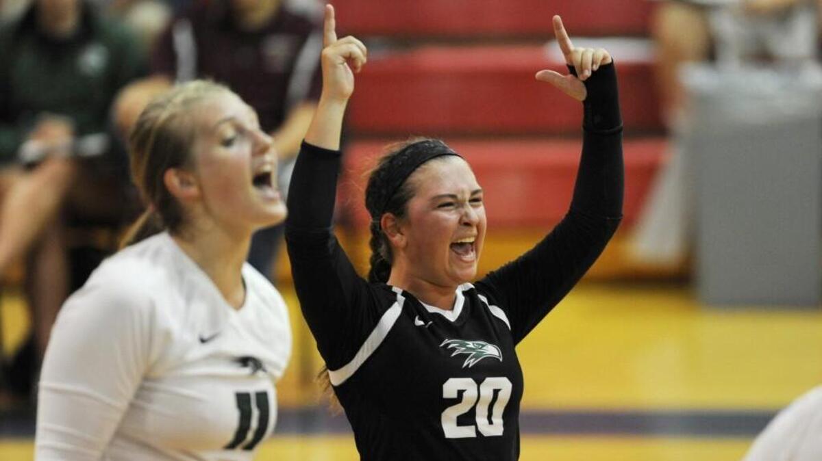 Green Hope's Kayla Dowler (11) and Erin McIndoe (20) celebrate a point against Sanderson in Raleigh, N.C. on Thursday, August 18, 2016.