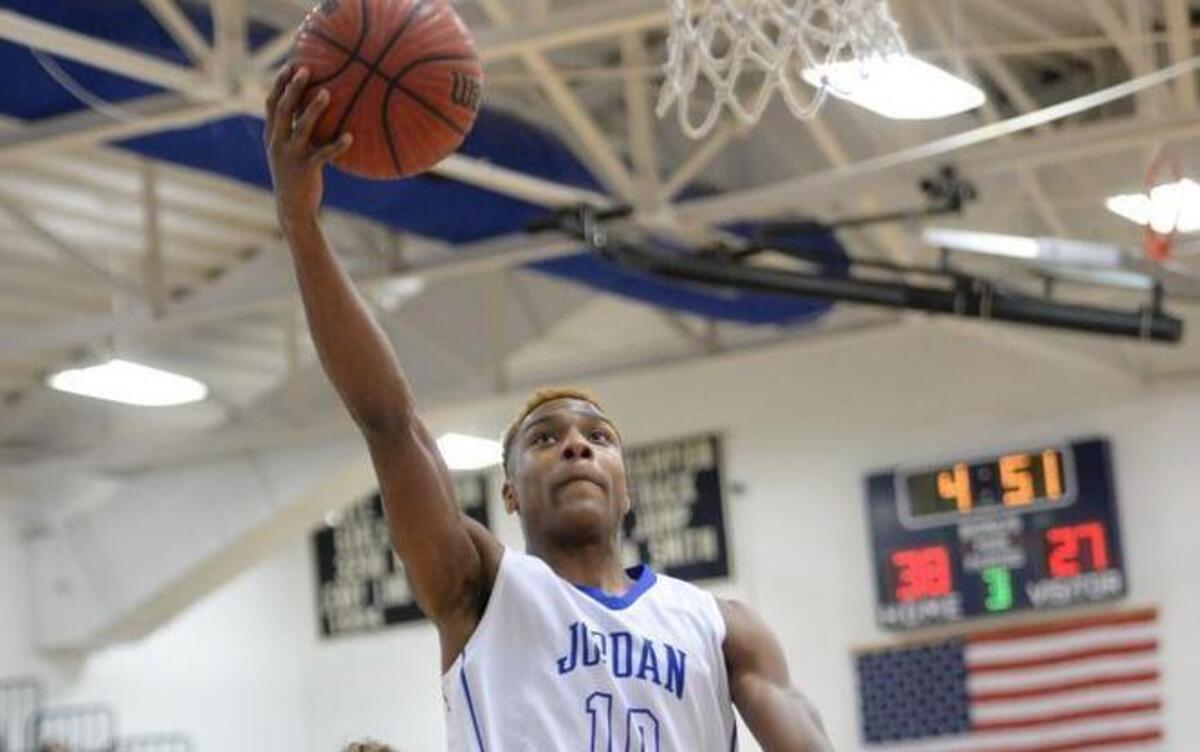 Rahim Mateen (10) of Jordan-Matthews scores with a layup against Christian Farrell (5) and Gordon Brann (20) of Northwood. The Jordan-Matthews Jets played the Northwood Chargers in a boys basketball game that took place in Siler City, N.C. on Saturday, January 16, 2016. Jordan-Matthews won 69-48.