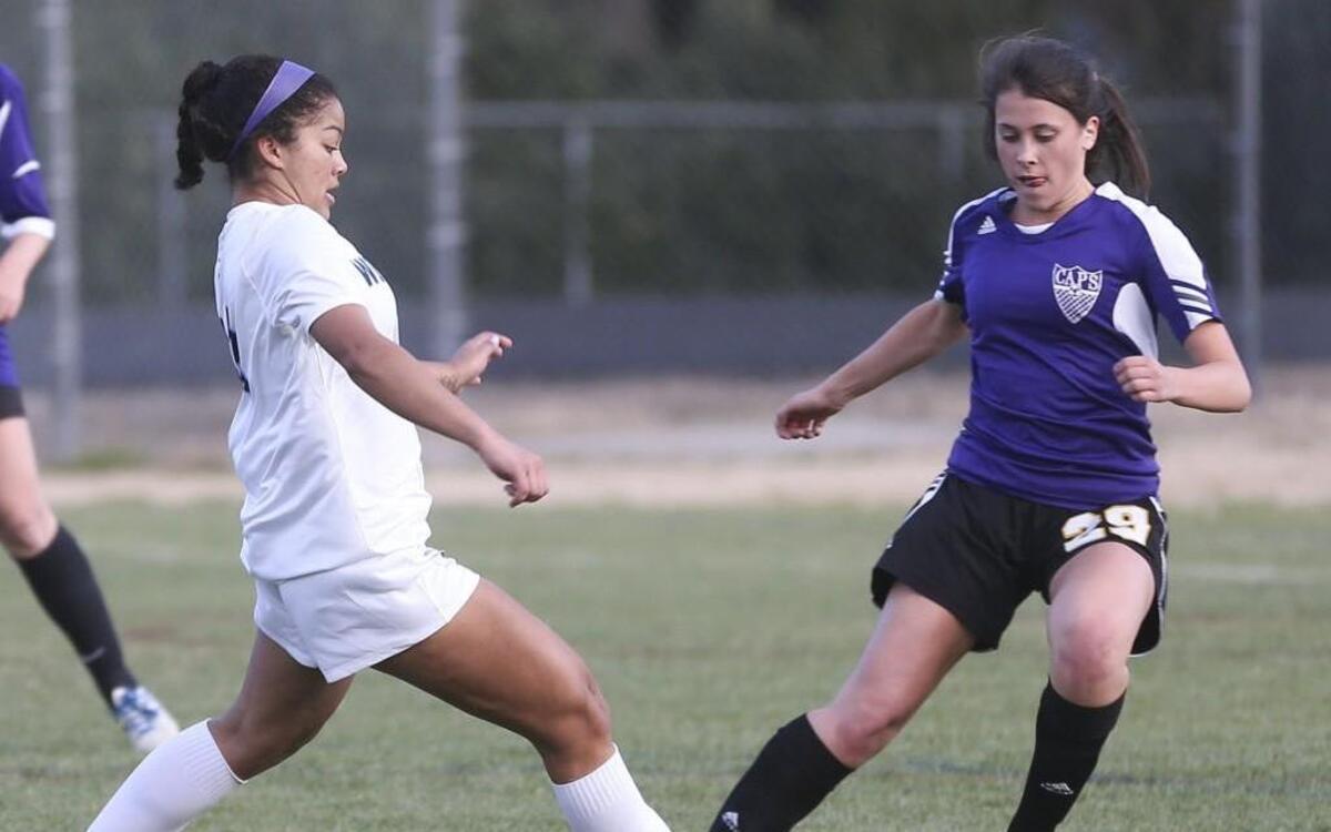 Millbrook's Brianna Morris (13) tries slip the ball past Broughton defender Lucy Krueger (29). Coverage from the prep soccer game between the Millbrook Wildcats and the Broughton Captials played in Raleigh, N.C. on Monday, March 20, 2017. Millbrook defeated Broughton 3-2 for the win.