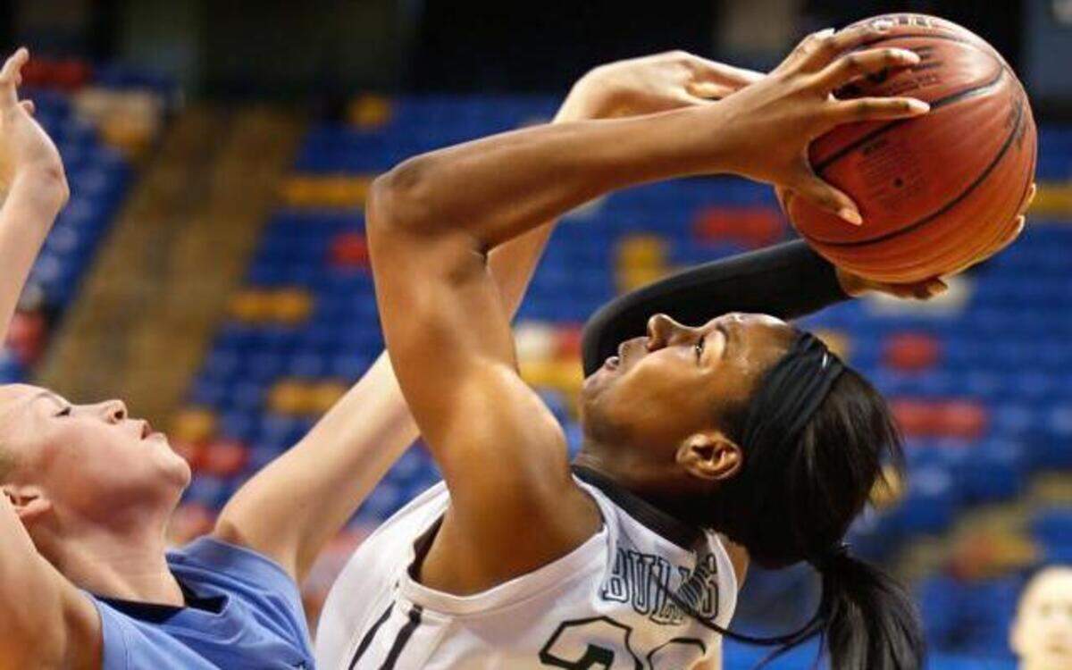 
Southeast Raleigh's Amber Richardson (23) puts up a shot while being fouled by Hoggard's Emma Haywood (34) during the NCHSAA east regional final between Southeast Raleigh and Wilmington Hoggard in Fayetteville, NC, on Sunday, March 7, 2015. Southeast Raleigh won the game 49-35, and Richardson was named tournament MVP.
