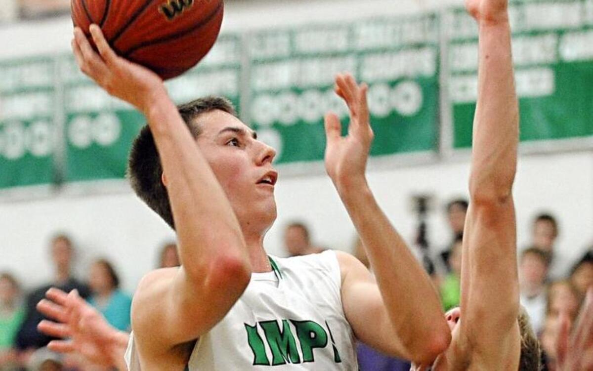 Cary’s Cory Gensler (left) shoots over Green Hope’s Conner Redick during their game Friday night in Cary.