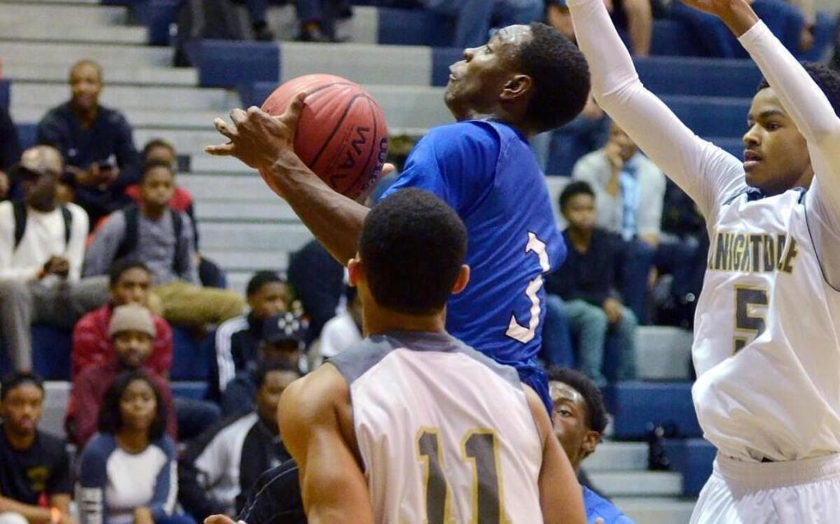 Clayton's Tre Armstead (3) drives between the Knightdale's Cole Johnson (5) and Dondre Griffin in a Greater Neuse River Conference boys basketball game in Knightdale, N.C. Tuesday, Dec. 15, 2015. The Comets won 77-66.