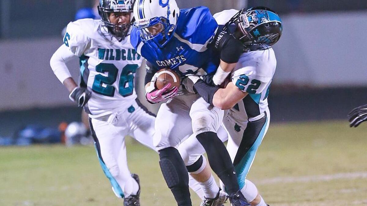 
Clayton High’s Blake Joyner (32) makes this reception and gets away from West Johnston defenders Brandon Baucom (22) and Deandre Blevins (26) for a last minute score before the half to get the Comets within one point at halftime. The Wildcats of West Johnston High School defeated the Comets of Clayton High School 27-25 played in Clayton, N.C. on Friday, October 31, 2014.
