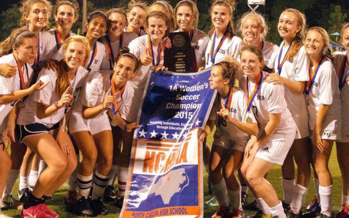 
Raleigh Charter players pose with their state championship banner after their 2-1 victory over Bishop McGuinness in the N.C. High School Athletic Association 1A championship in Raleigh, NC on Saturday May 30, 2015.
