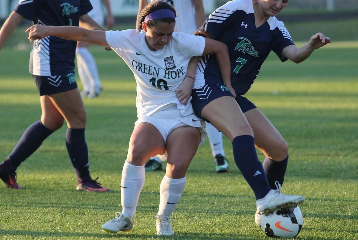 Green Hope's Taylor Cammarata (16) battles Leesville Road's Cayley Kennedy (7) for the ball during the Leesville Road high school soccer match with Green Hope high school in the third round of the state high school playoffs at Cary N.C. on May 16, 2017. Green Hope won 5-0.