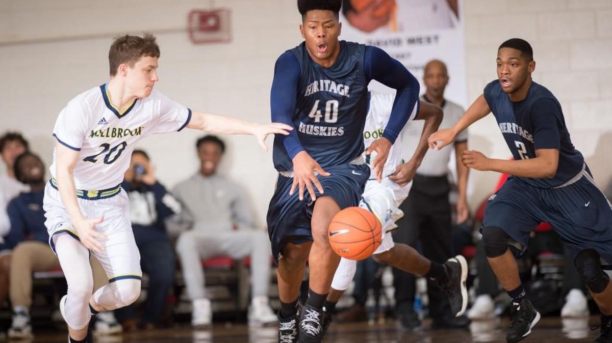 Heritage's Jayden Gardner (40) get the rebound and starts the break during matchup between Millbrook and Heritage at The John Wall Family Foundation 45th Holiday Invitational that took place at Broughton High School on December 28, 2016 in Raleigh, North Carolina. Heritage defeated Millbrook 67-43.