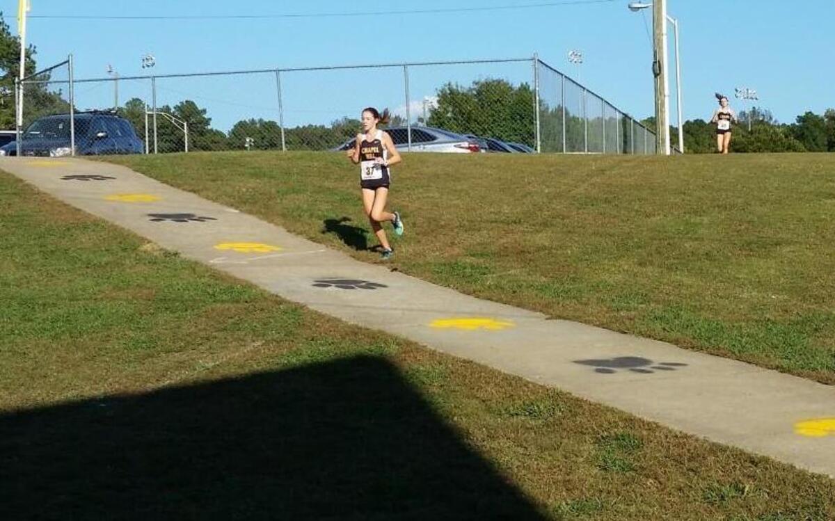 Chapel Hill junior Katherine Dokholyan (37) separates from Tiger teammate Clare McNamara as they had toward the last 300 meters of the 2016 Big 8 Cross Country championship race, held Wednesday, Oct. 19, at Chapel Hill High School.