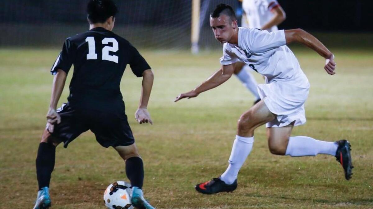
Green Hope’s Griffin Brookshire, right, defends against Wakefield in the first round of the NCHSAA 4A playoffs on Oct. 29, 2014.
