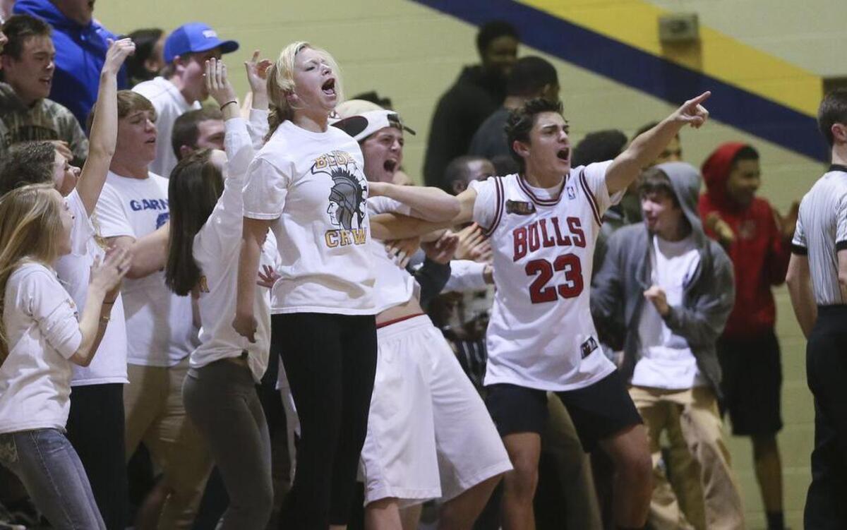 
The Trojan fans react after an acrobatic Julius Barnes layup. The Trojans of Garner High School defeated the Knights of Northern Durham High 73-61 played in Garner, N.C. on Tuesday March 3, 2015.
