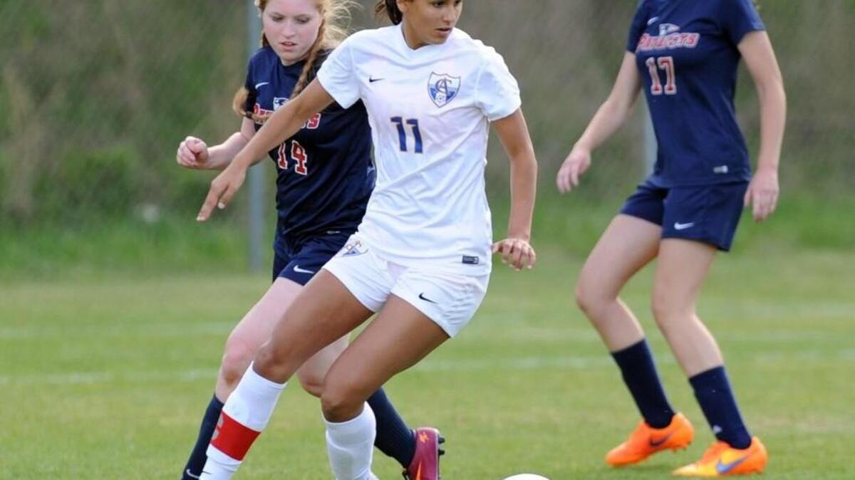 Cary Academy’s Remi Swartz (11) redirects the ball from Franklin Academy's Taylor Kassay (14) during the girls soccer game in Cary on Friday, April 15, 2016. Cary Academy won 7-0.