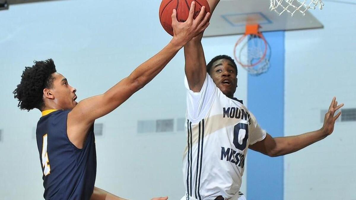 Northern Durham's Tahj Small (4) attempts the layup while defended by Mountain Mission's Harold Baruti (0) The Northern Durham Knights took on the Mountain Mission Challengers in the finals of the Navy bracket of the South Granville Holiday Tournament held in Creedmoor, N.C. on Wednesday December 30, 2015. Mountain Mission wins 69-64.