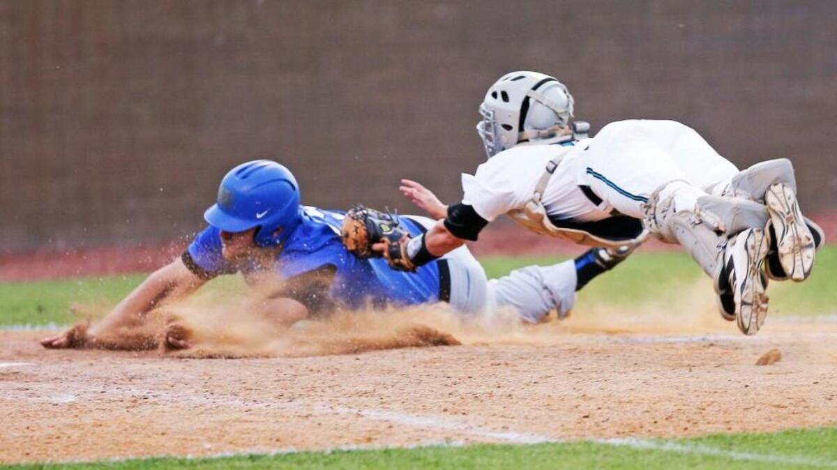 West Johnston catcher Peyton Richards (14) just nicked the shirt of Clayton’s Brooks Verona (25) for the out to end a fourth-inning rally by the Comets.