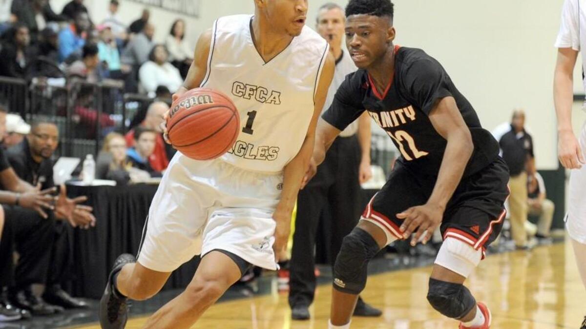 Cape Fear's Quentin Jackson (1) drives past Trinity's Cameron Campbell (12) during the NCISAA 1A boys championship basketball game, which was played in Raleigh on Saturday, February 20, 2016. Trinity Christian won 75-66.