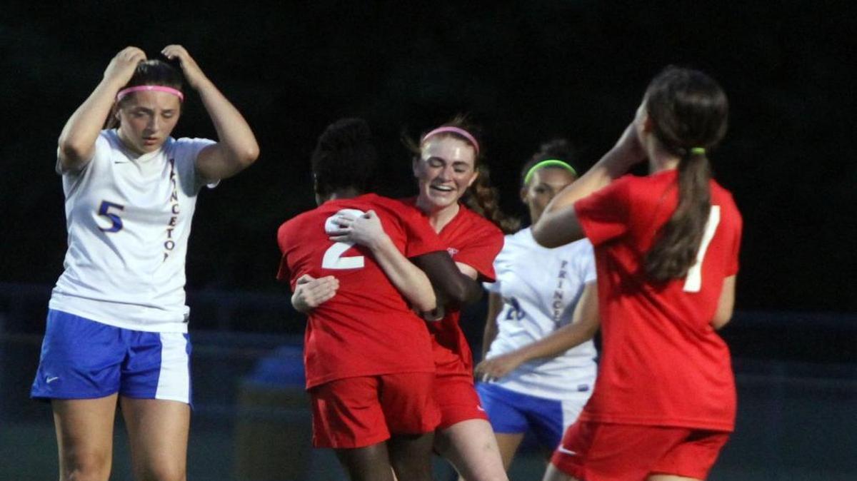 Voyager Academy's Audree Catlin (2) gets a hug from Marlie Shaw after scoring during the Voyager Academy at Princeton girls' soccer game in the first round of the NCHSAA 1-A state playoffs in Princeton, N.C. on Tuesday, May 9, 2017.