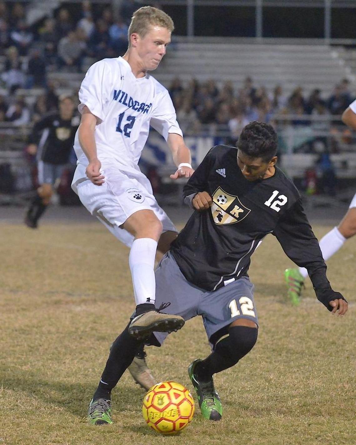 Milbrook's Emmet Wood (12) challenges Knightdale's Alexis Candela (12) for control of the ball during the second half. The Knightdale Knights took on the Millbrook Wildcats in the second round of the NCHSAA 4A playoffs in Raleigh, N.C. on November 8, 2016.