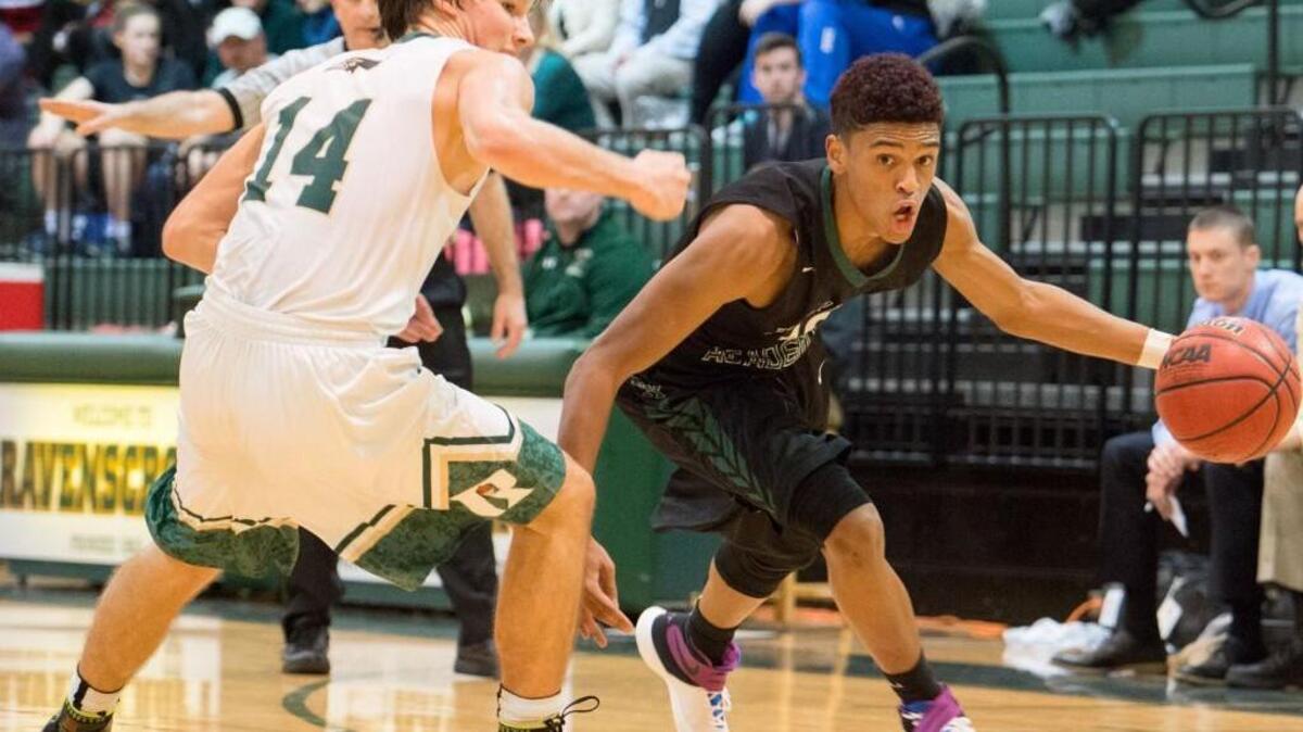 Durham Academy’s Jorden Davis (10) drives around Ravenscroft’s Chris Barnette (14) Jan. 11 in Raleigh, N.C.