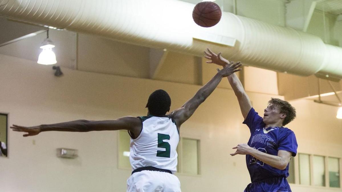 Brougton's Jack Holloway, right, attempts a shot over Enloe's Moses Wright (5), during a high school basketball game in Raleigh, N.C. on Wednesday, Jan. 18, 2017.