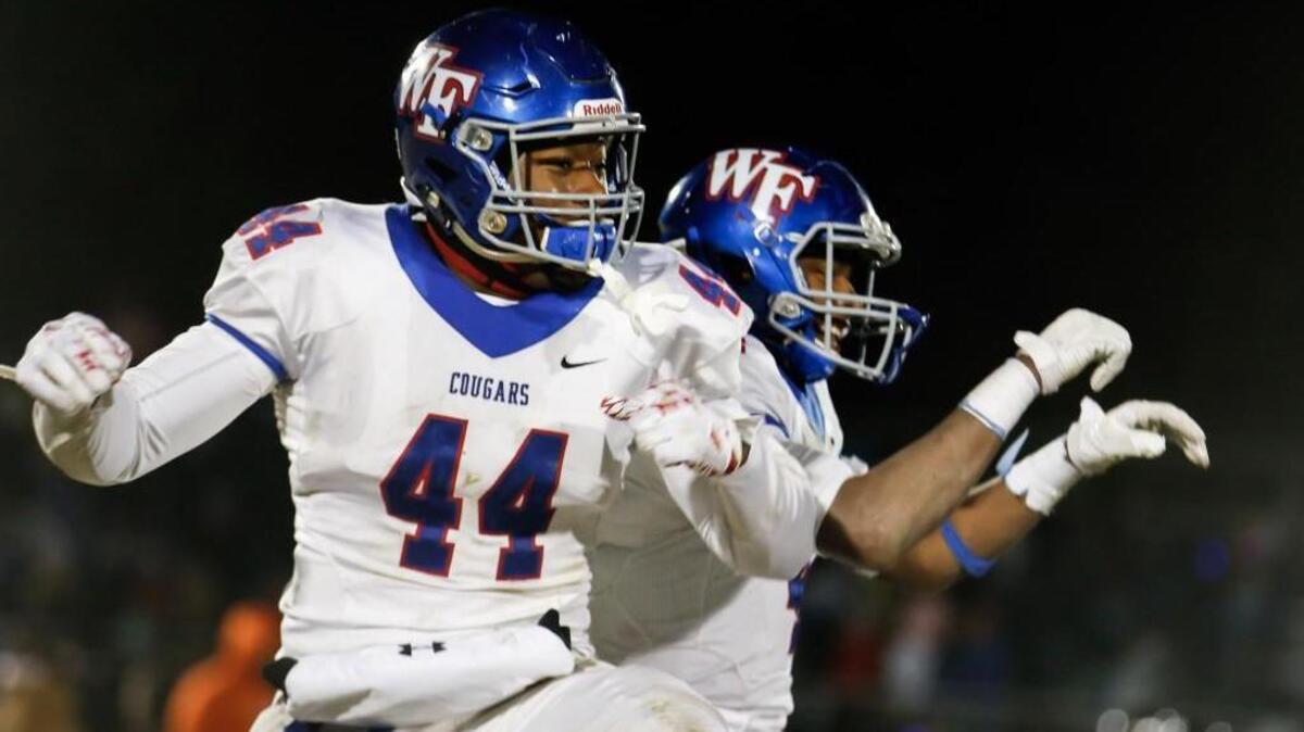 Wake Forest's Darius Hodge (44) and Delante Lucas celebrate following Wake Forest's semi-final playoff game at Middle Creek on Friday, December 9, 2016. Wake Forest won the game 20-17 in overtime, and will play in the 4AA state championship.