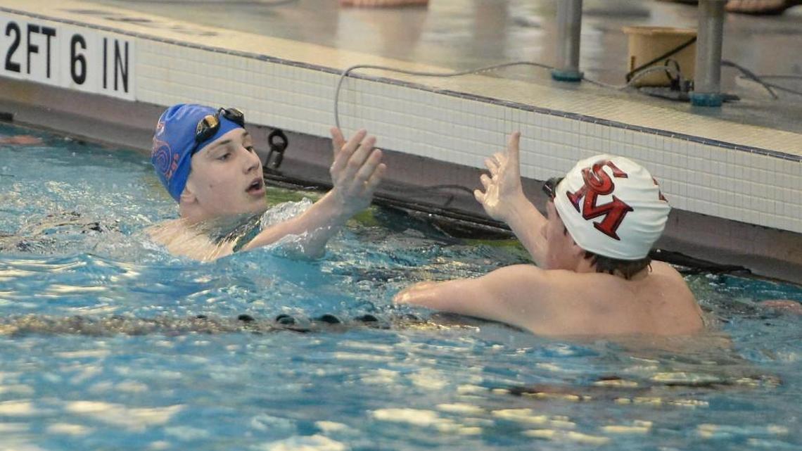 Zach Brown, left, of Athens Drive is congratulated by Luke Johnson, right, of South Mecklenburg at the end of th Men 200 Yard Individual Medley race during the NCHSAA 4A Swimming Championships that took place at the Triangle Aquatic Center in Cary, N.C. on Friday, February 10, 2017.