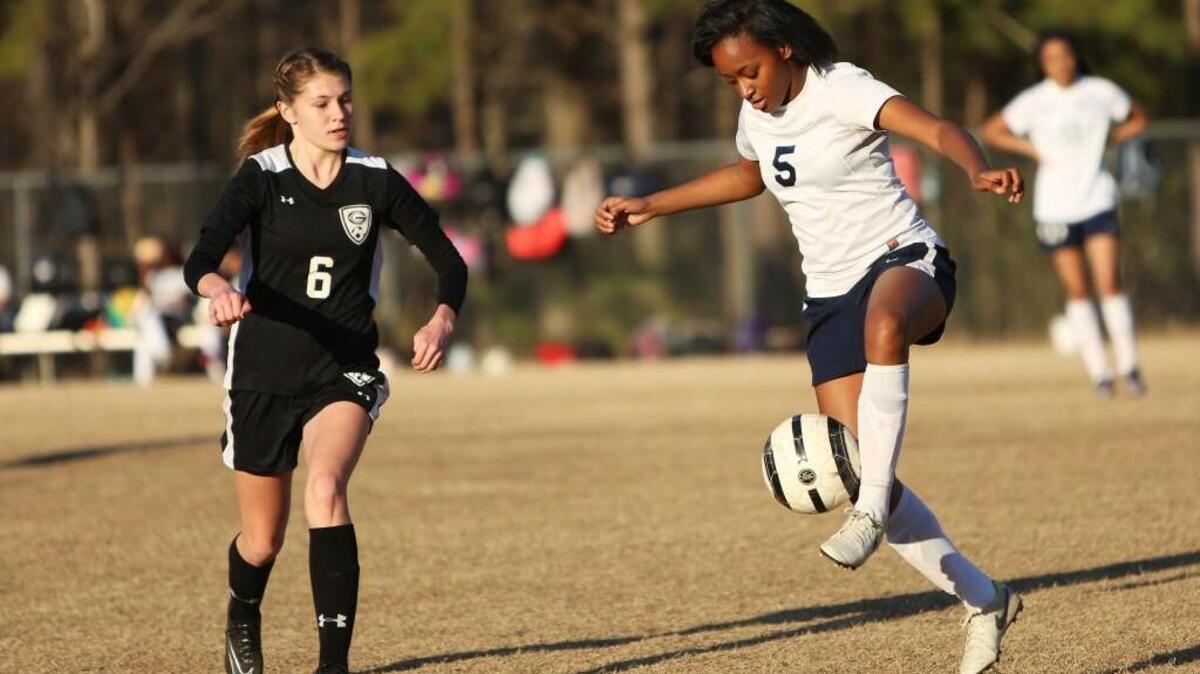 Hillside's Adora Harris (5) traps and controls the ball during the Granville Central girl's soccer team's 1-0 win over the Hillside Hornets at Hillside High School in Durham, N.C., Tuesday, March 23, 2017.