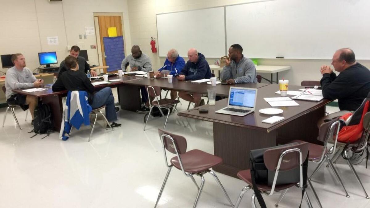 Officials from the Two Rivers 3A Conference member schools discuss the rescheduling of events postponed by Hurricane Matthew this week. From left, South Johnston volleyball coach Matthew Adams, Triton athletics director Wendy Gaines, South athletics director Brody Massengill, Smithfield-Selma athletics director Marvin Burke, Western Harnett athletics director Russell Taylor, Cleveland athletics director Jamie Lee, Cleveland coach Wayne Stewart and Corinth Holders athletics director and conference president Brent Walston.