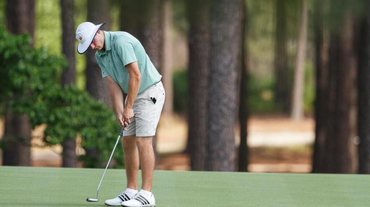Leesville Road's Doc Redman sinks this putt on 14 during the NCHSAA 4A Men's Golf Championship at Pinehurst Country Club in Pinehurst, NC on Monday May 11, 2015.