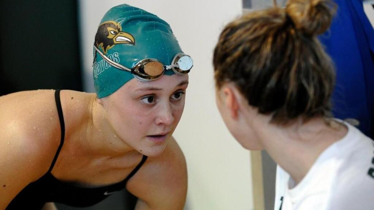Ravenscroft’s Kaitlin Ramsden talks with a teammate after winning her heat in the girls 50-yard freestyle during the TISAC conference meet in Raleigh in February.